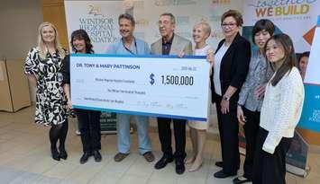 Doctor Tony Pattinson, fourth from left, and Mary Pattinson, fifth from left, present a cheque to the Windsor Regional Hospital Foundation, April 22, 2025. Photo by Mark Brown/WindsorNewsToday.ca.